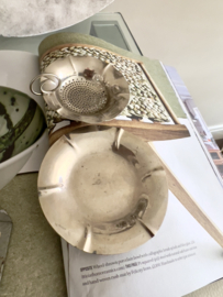 Old tea strainer with plate