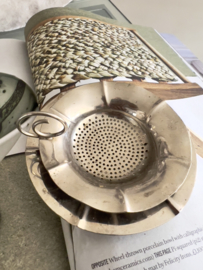 Old tea strainer with plate