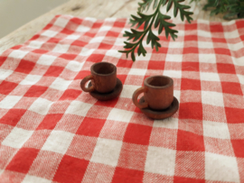 brown cup and saucer