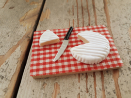 camembert cheese on board with knife