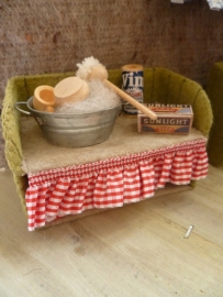 tub with brush, soap and a tea towel