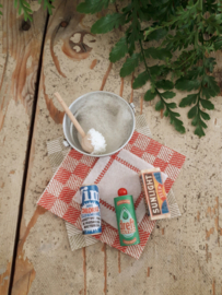 tub with brush, soap and a tea towel