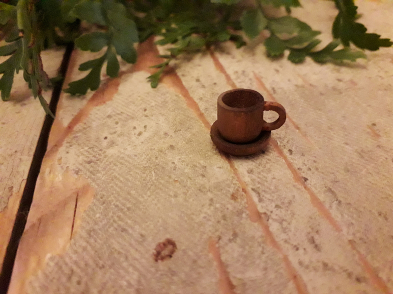 brown cup and saucer