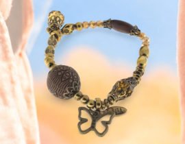 Elastische Biba armband oud goud en geel koper kleur vlinder