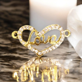 Metalen Hart met tekst "Love"  tussenzetsel twee ogen met strass steentjes, goud kleur, afm.  30 x 16 x 2mm