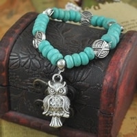 Prachtige Turquoise armband met elastiek + uil bedel