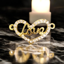 Metalen Hart met tekst "Love"  tussenzetsel twee ogen met strass steentjes, goud kleur, afm.  30 x 16 x 2mm