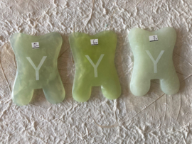 Jade guasha steen met Y ets ter versterking van de behandeling, dun