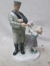 German statue made of china, nicely marked. Porseleinen beeld ( vaas) van een Duitse soldaat die gewond uit de Eerste Wereldoorlog terug komt en bloemen krijgt overhandigd. genummerd en gemerkt Zeldzaam stuk. TOP 19 cm..