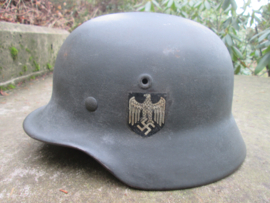German helmet M40 with Wehrmacht decal.  Duitse helm zandgeverfd met Wehrmacht decal maat ET64. kinriem helaas gebroken binnenhelm in perfecte staat zeer nette en keurige helm.