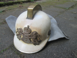 Dutch firehelmet of the City of Amsterdam, with solid brass frontbadge, hard to find helmet. Amsterdamse brandweerhelm Kraayer model met massief koperen embleem, zeldzame helm, moeilijk te vinden. mooi gedragen staat met brede leren kinband.