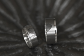 Vingerafdruk ring Titanium met zilveren binnenzijde en uitstekende rand.