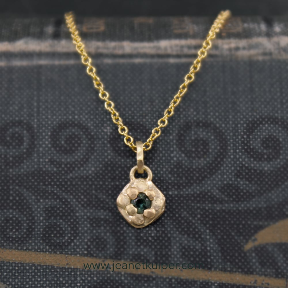 Pendant with a green-blue sapphire