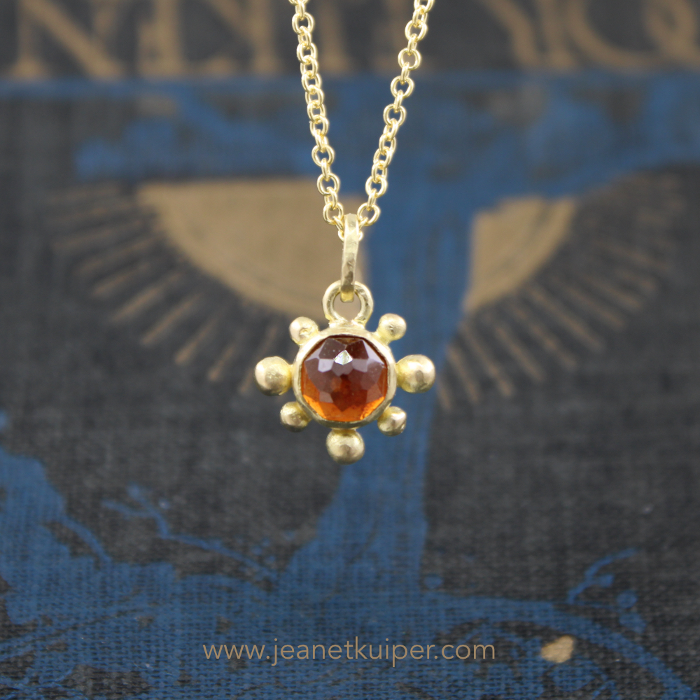 Sunpendant with a rose cut hessonite garnet