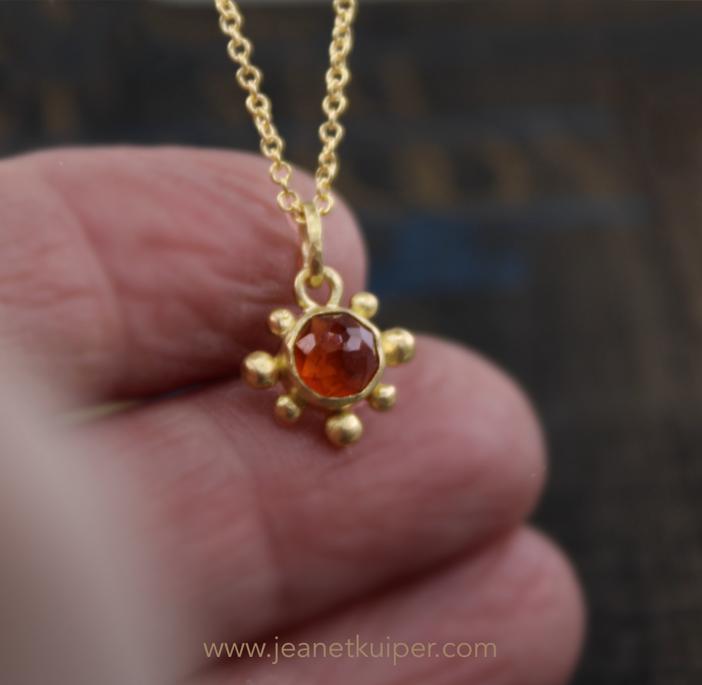 Sunpendant with a rose cut hessonite garnet