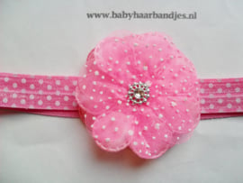 Donker roze stippel baby haarband met bloem.