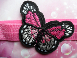 Smalle donker roze baby haarband met vlinder.