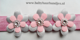 Smalle donker roze baby haarband met bloemetjes.