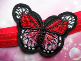 Smalle rode baby haarband met vlinder.