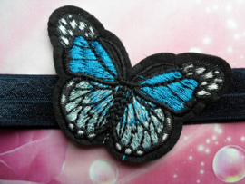 Smalle donker blauwe baby haarband met  vlinder.