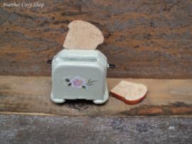 Dollhouse miniature toaster with two pieces of toast in 1" scale