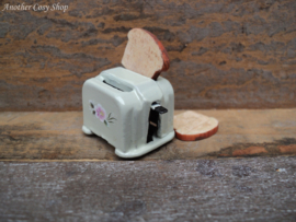 Dollhouse miniature toaster with two pieces of toast in 1" scale