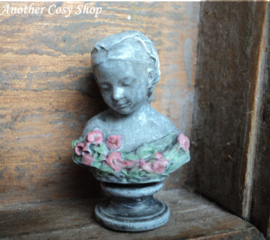 Dollhouse miniature bust of a girl with a headscarf