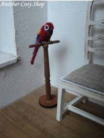 Dollhouse miniature parrot on a stick in one inch scale