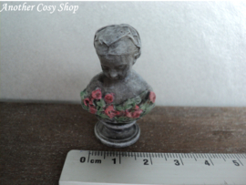 Dollhouse miniature bust of a girl with a headscarf