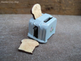 Dollhouse miniature toaster with two pieces of toast in 1" scale