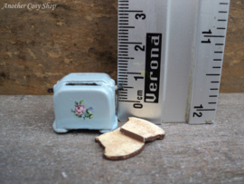 Dollhouse miniature toaster with two pieces of toast in 1" scale