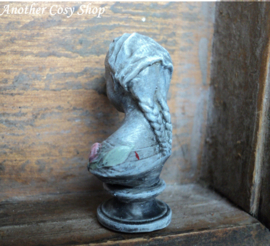 Dollhouse miniature bust of a girl with a headscarf