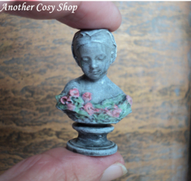 Dollhouse miniature bust of a girl with a headscarf