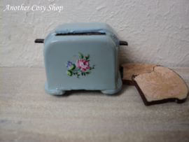 Dollhouse miniature toaster with two pieces of toast in 1" scale