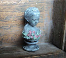 Dollhouse miniature bust of a girl with a headscarf