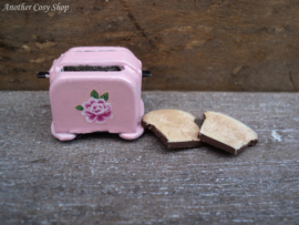 Dollhouse miniature toaster with two pieces of toast in 1" scale