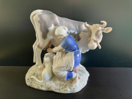 Bing & Grondahl porselein: nr. 2017 Milkmaid and Cow, beeld koe met melkster hoog 19 cm breed 23 cm diep 15 cm