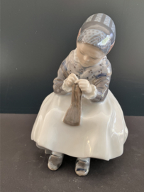 Royal Copenhagen porselein: nr. 1314 Amager Girl Knitting / Lille Strikkende Amargerpige ontwerp Lotte Bentler hoog 16 cm