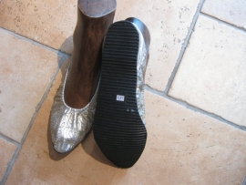 Schoenen goud- of zilverkleur met een rubberen zool en een klein hakje. Ook met borduursel te krijgen