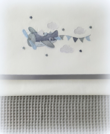 Wieglaken 75 cm x 100 cm in wit/ grijs 'vliegtuig met vlaggetjes' geborduurd