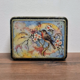 Vintage decoratief blikje met een vogelmotief