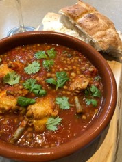 Tomato lentil stew with pollo al ajillo chicken