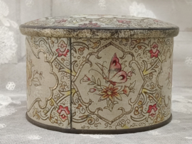 Oud rond gebloemd blikje