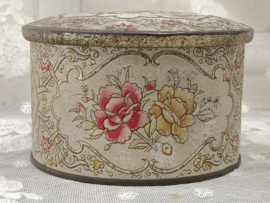 Oud rond gebloemd blikje