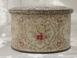 Oud rond gebloemd blikje