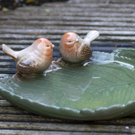 Ceramic leaf shaped bird bath with birds