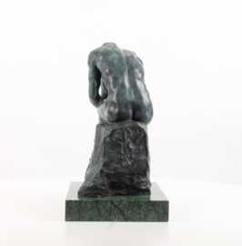 Een bronzen beeld van de denker