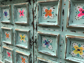 Blue cabinet with colored flowers