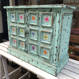 Blue cabinet with colored flowers