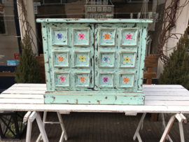 Blue cabinet with colored flowers